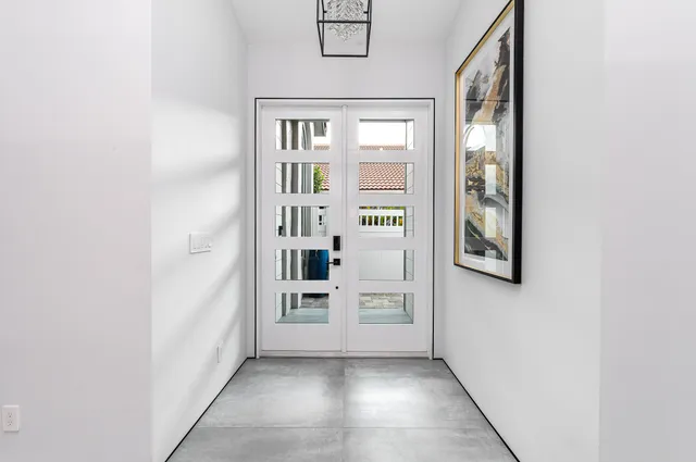 a kitchen with appliances cabinets and chair