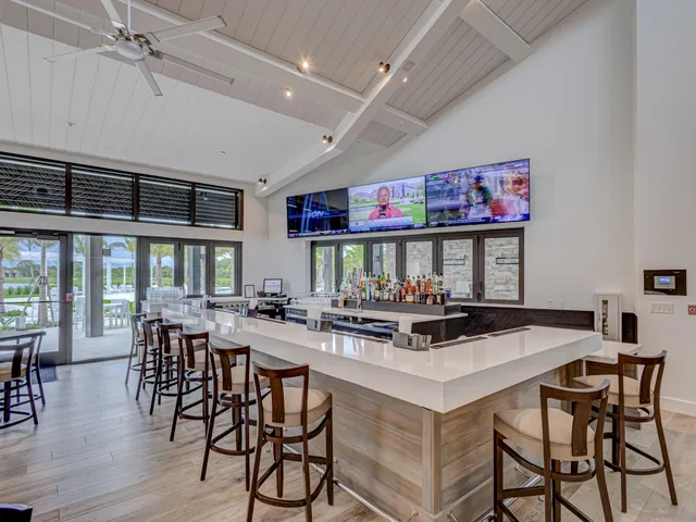 an aerial view of residential houses with outdoor space and swimming pool