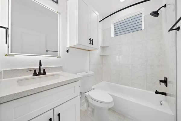 a bathroom with a sink a toilet and a bathtub