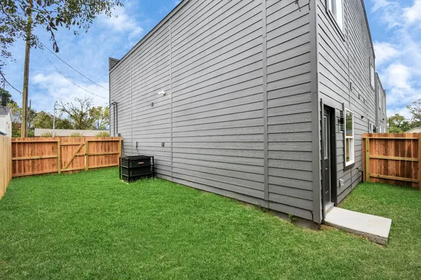 a view of a backyard with wooden fence