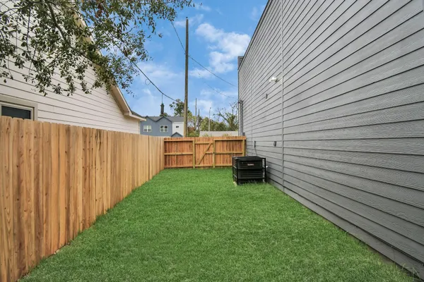 a view of a backyard with wooden fence
