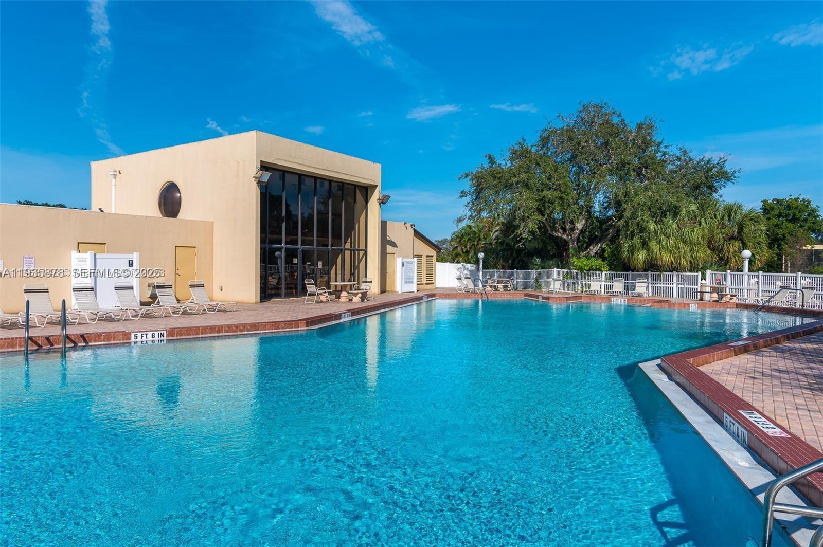 2931 Southwest 87th Terrace, Unit 1923 Davie, FL 33328 - Photo 15 of 15 a swimming pool with outdoor seating and yard