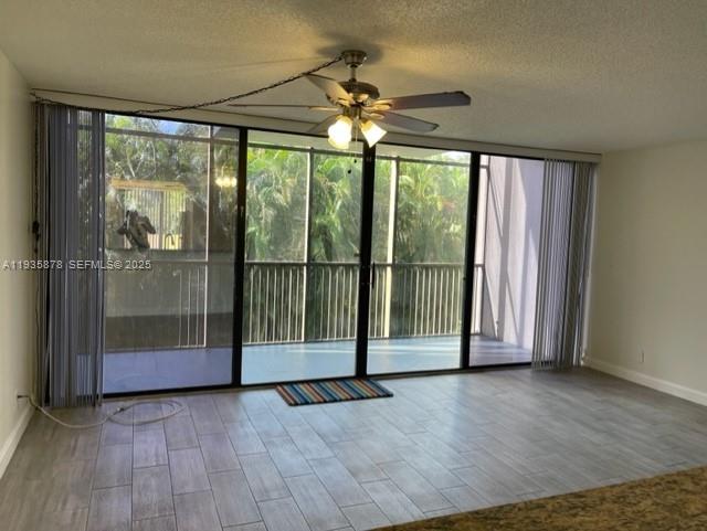 2931 Southwest 87th Terrace, Unit 1923 Davie, FL 33328 - Photo 7 of 15 an empty room with wooden floor and windows
