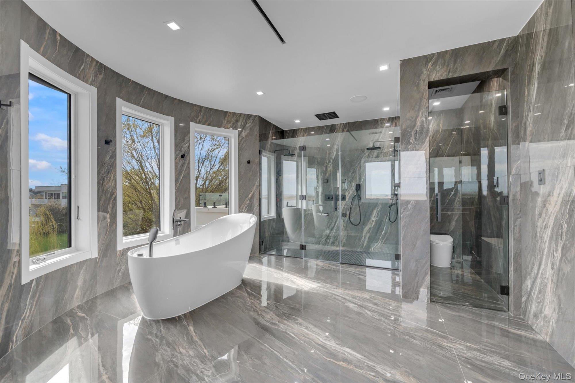 190 Curtis Road Woodmere, NY 11598 - Photo 27 of 46 a spacious bathroom with a bathtub and a shower