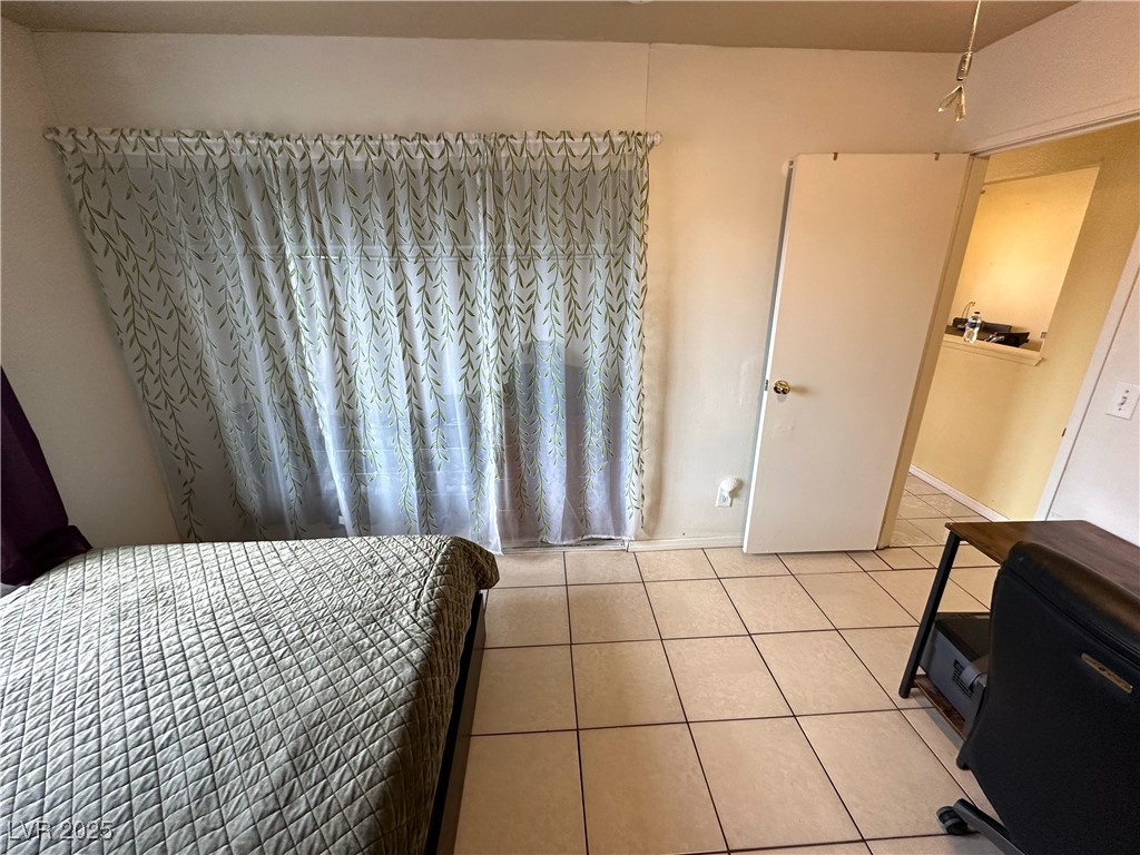 3936 Rive Gauche Street Las Vegas, NV 89115 - Photo 23 of 30 Bedroom with light tile patterned floors and baseboards