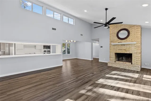 a view of empty room with wooden floor and fireplace