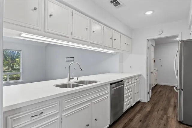 a kitchen with stainless steel appliances granite countertop a sink and cabinets