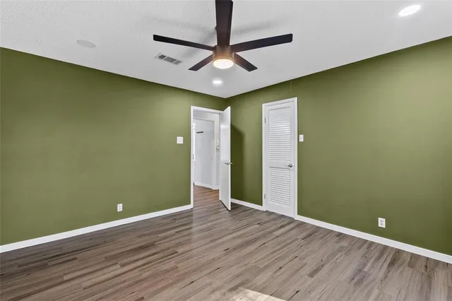 a view of a room with wooden floor