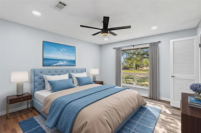 a bedroom with bed and window