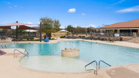 a kitchen with stainless steel appliances granite countertop a sink a stove and a wooden cabinets