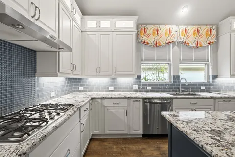 a kitchen with a sink stove and cabinets