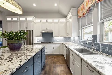 a living room with furniture a chandelier and a flat screen tv