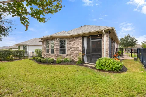 a view of backyard of house with green space