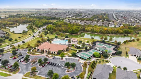 a living room with furniture a flat screen tv and a table