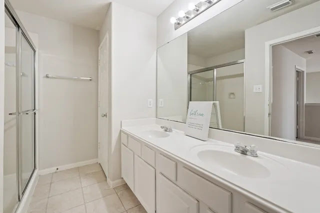 a spacious bathroom with a double vanity sink mirror and double