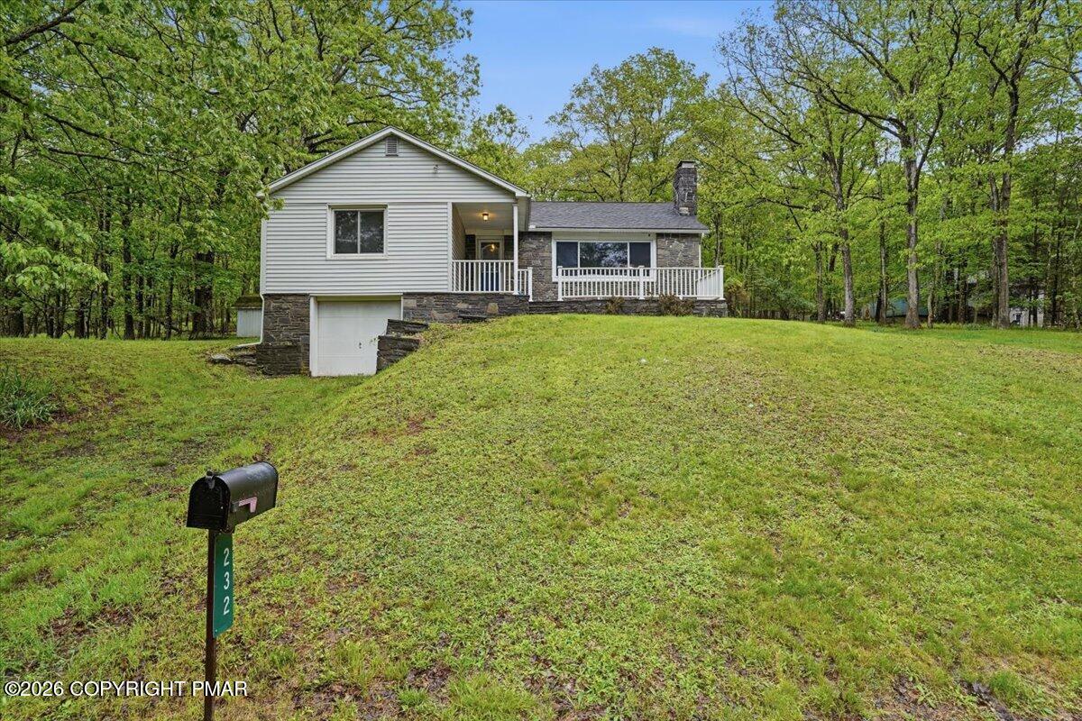 232 Garrity Road Hawley, PA 18428 - Photo 46 of 57 a front view of a house with a yard and trees