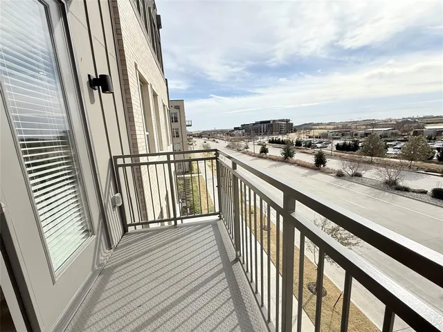 a view of a balcony with wooden floor and fence