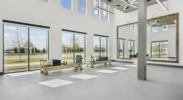 a swimming pool with outdoor seating and a large window