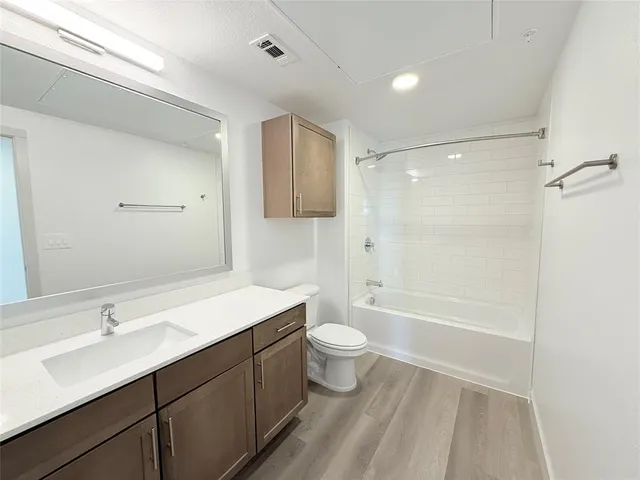 a bathroom with a sink a toilet a shower and a mirror