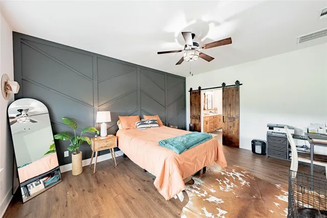 a bedroom with a bed a table and chair