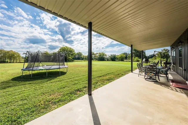 a view of a backyard with sitting area