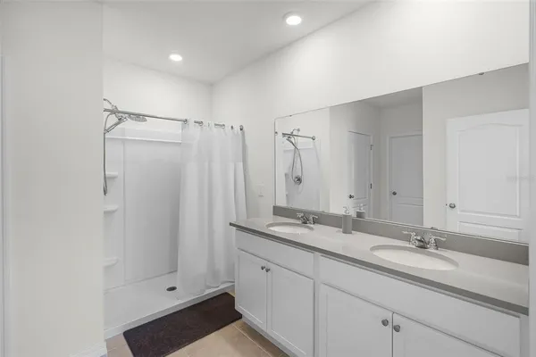 a bathroom with double sink and a mirror
