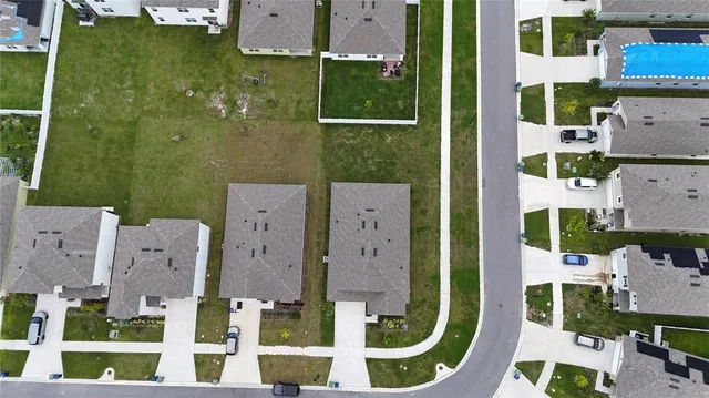 aerial view of multiple houses with yard