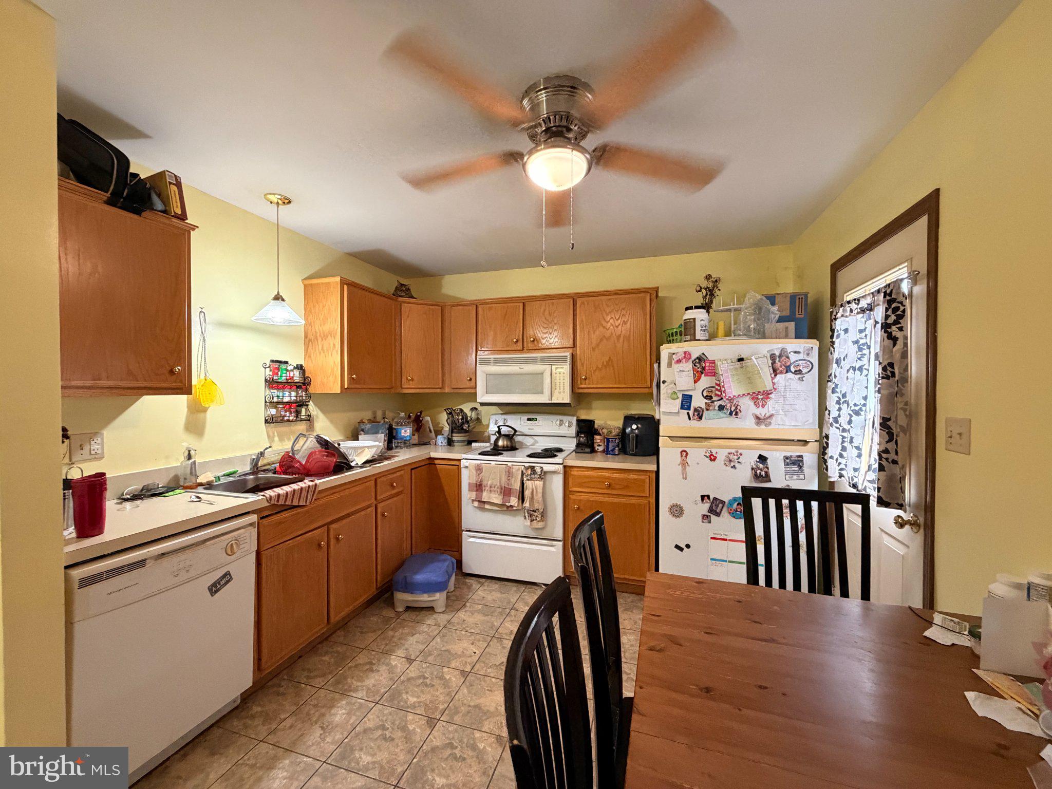 10 Taylor Drive, Unit J Reedsville, PA 17084 - Photo 4 of 11 Cozy kitchen with warm yellow tones.