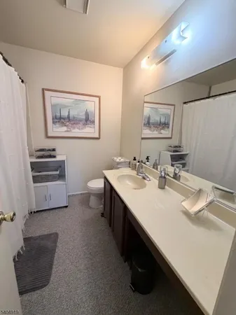 a bathroom with a sink a vanity and a mirror
