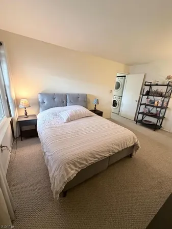 a large bed sitting in a bedroom next to a lamp