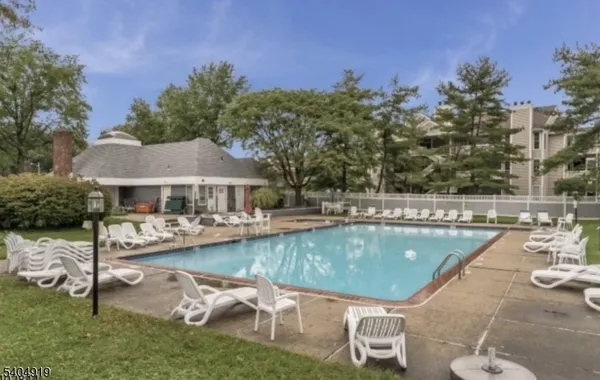 a view of a swimming pool with lounge chairs