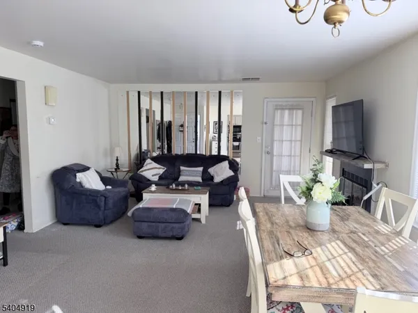 a living room with furniture flowerpot and a window