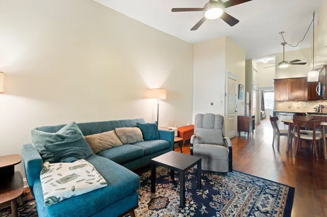 a living room with furniture and a chandelier