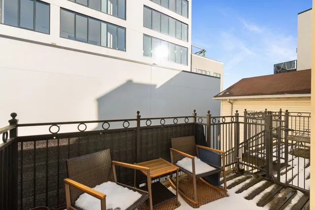 a view of a roof deck with furniture