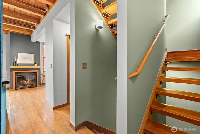 a view of a livingroom with wooden floor and a fireplace