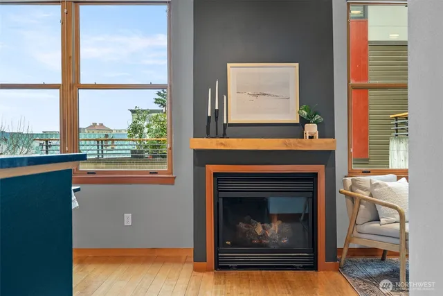 a living room with a fireplace and windows