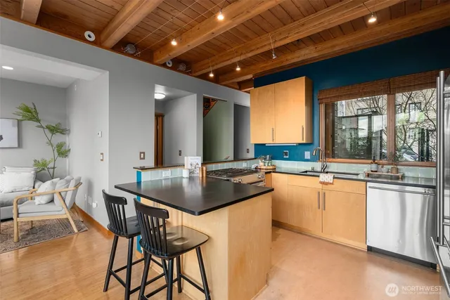 a kitchen with a dining table chairs and white cabinets