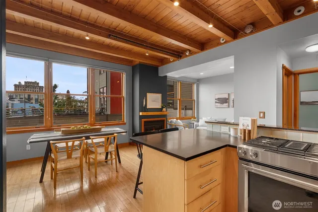 a kitchen with granite countertop a table chairs stove and cabinets