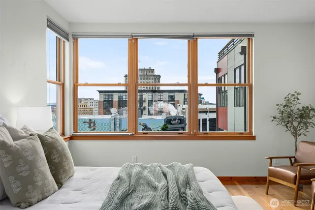 a bedroom with furniture and a large window