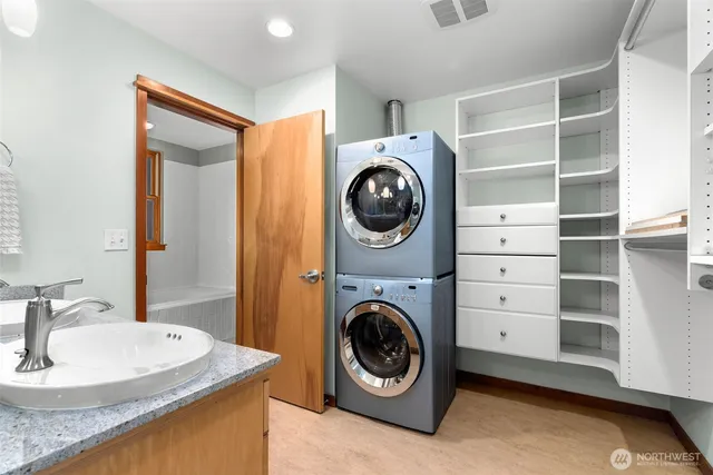 a utility room with sink dryer and washer