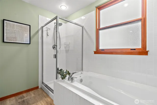 a bathroom with a bathtub and a shower