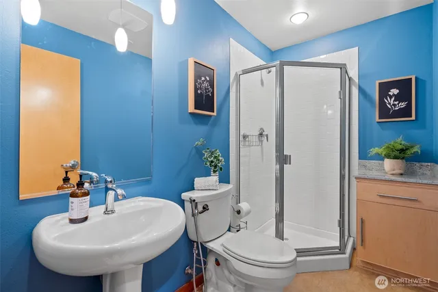 a bathroom with a sink toilet and shower