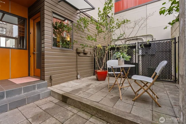 a view of a patio with a table and chairs and potted plants