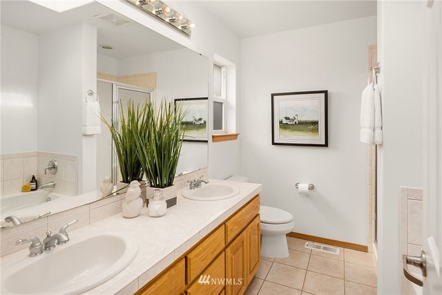 a bathroom with a sink a toilet and mirror