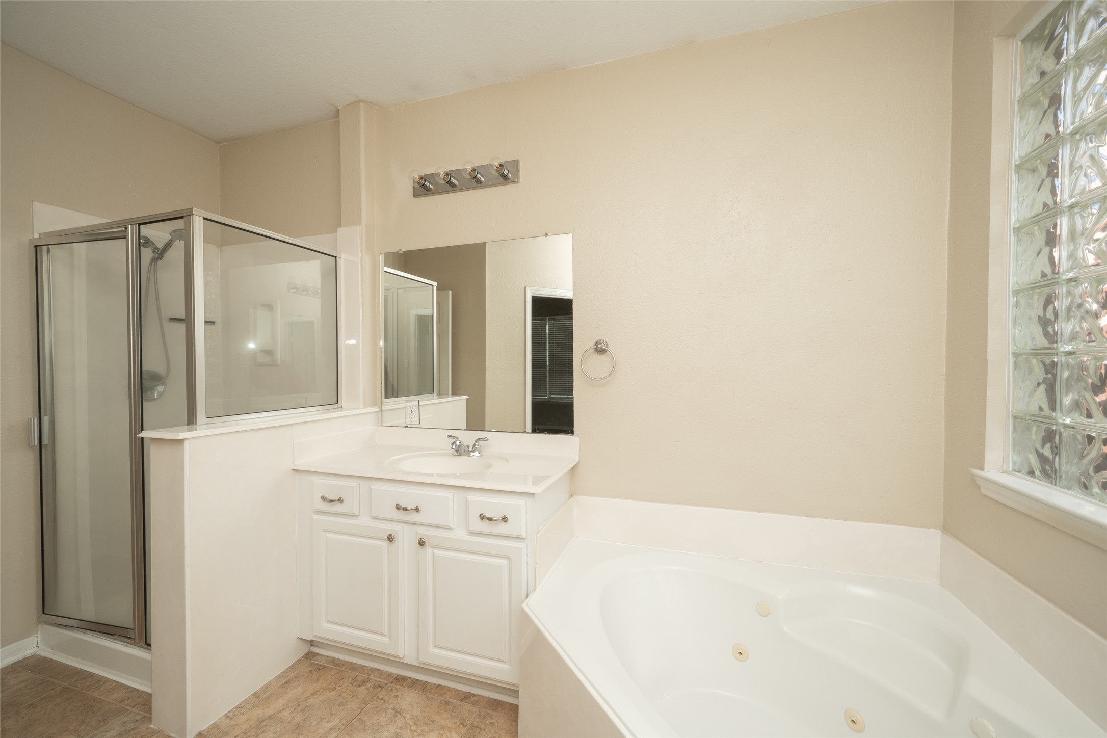 14410 Floret Estates Lane Cypress, TX 77429 - Photo 19 of 27 a bathroom with a bathtub sink and mirror