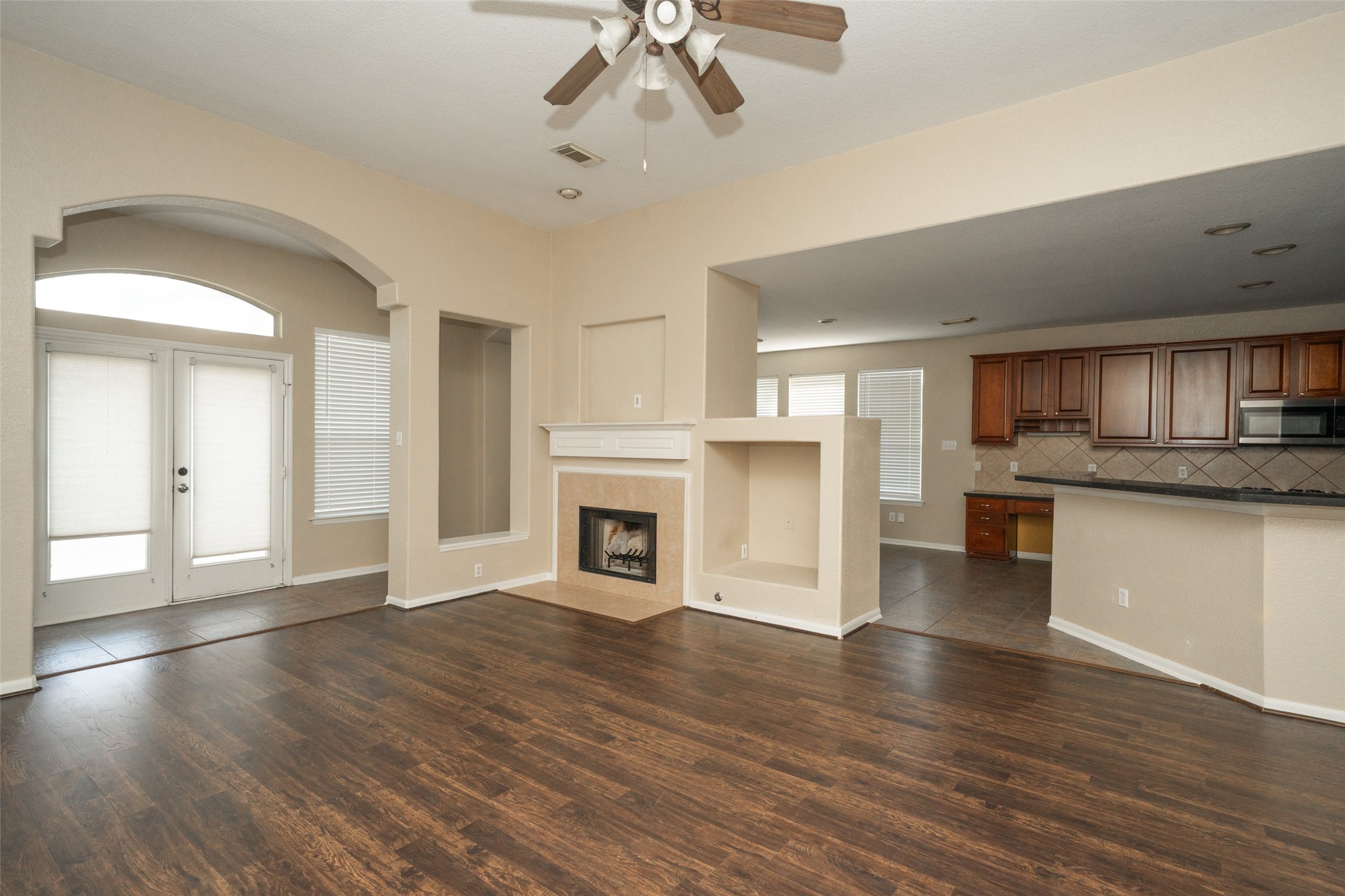 14410 Floret Estates Lane Cypress, TX 77429 - Photo 21 of 27 a view of a kitchen with a stove cabinets and wooden floor