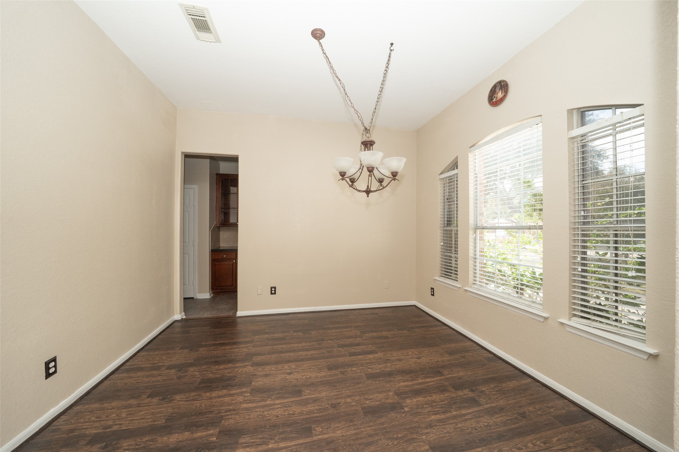 14410 Floret Estates Lane Cypress, TX 77429 - Photo 4 of 27 an empty room with wooden floor and windows