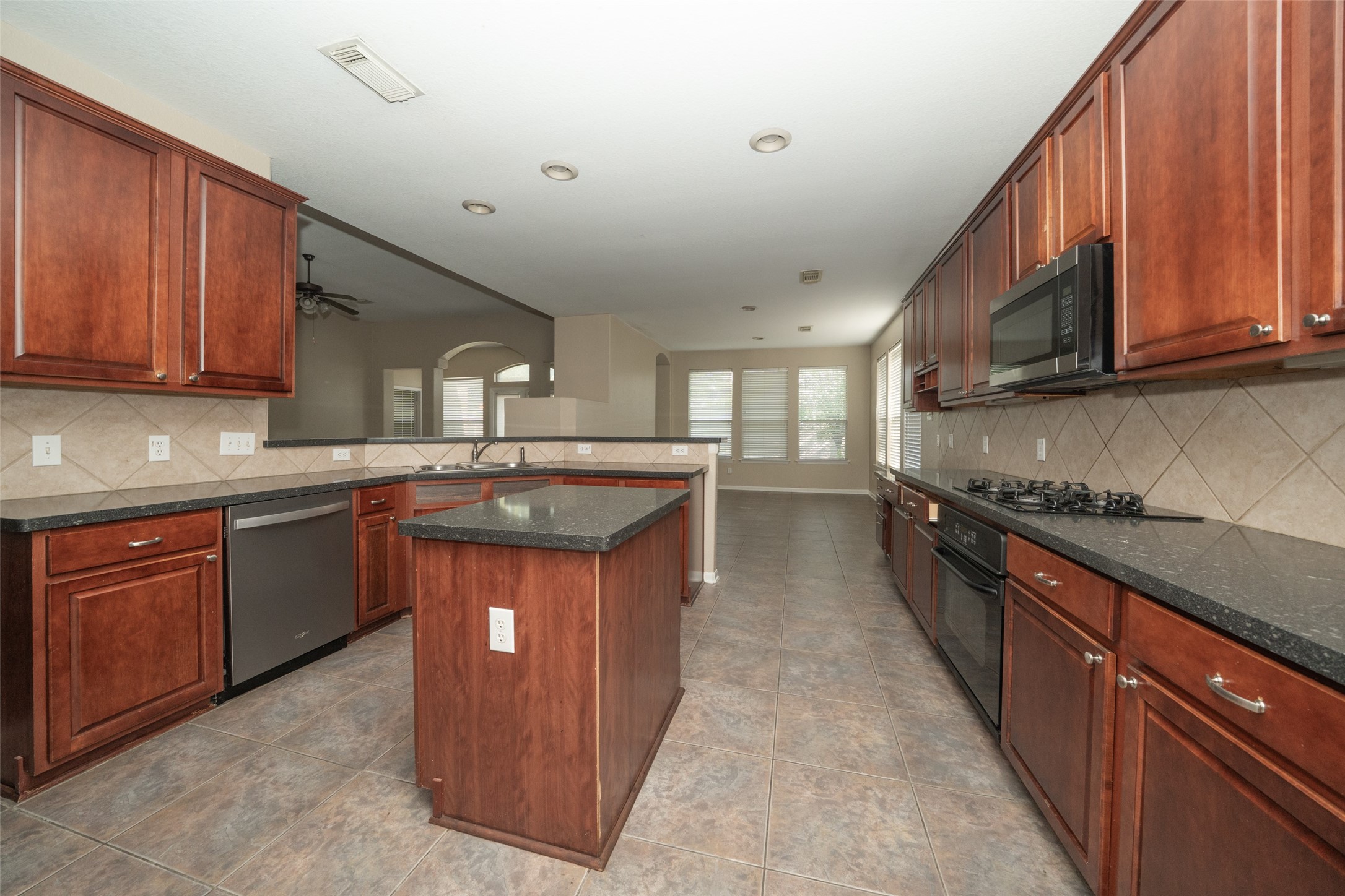14410 Floret Estates Lane Cypress, TX 77429 - Photo 10 of 27 a kitchen with stainless steel appliances granite countertop a sink stove and cabinets