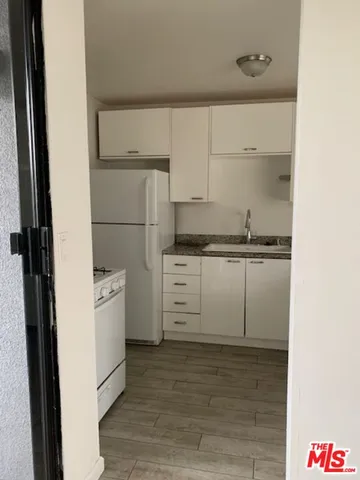a close view of a stove a sink and dishwasher in a kitchen