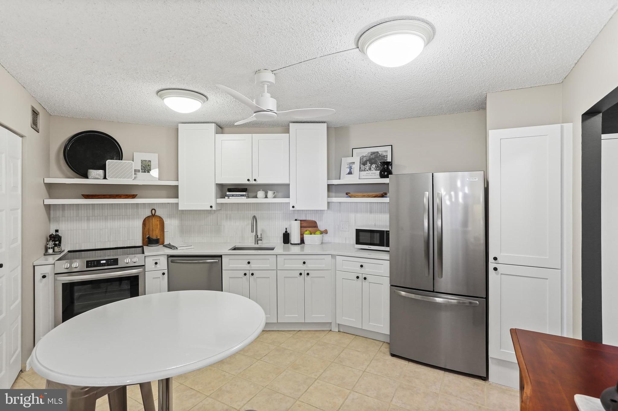 205 East Joppa Road, Unit 1907 Towson, MD 21286 - Photo 1 of 33 a kitchen with stainless steel appliances a refrigerator sink and stove